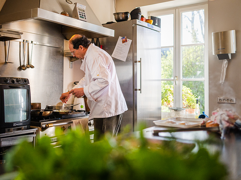 Michelin Green Star: Vincent Cuisinier de Campagne restaurant, Loire Valley, France. Vincent Simon in his kitchen, doing his best while cooking a new delicious meal insipred by french culinary. You'd better book for a lunch or for dining, as the price is not expensive.